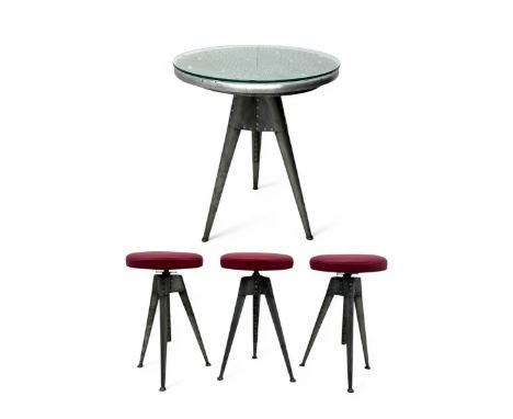 Contemporary industrial design riveted metal table, by repute fashioned from salvaged aeroplane parts, with a circular glass 