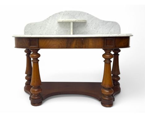 Mid-19th century mahogany washstand, the serpentine white marble top with raised gallery back and central shelf above a friez