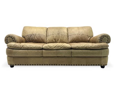 Contemporary three-seat sofa, upholstered in stitched brown leather with brass studwork decoration, rolled back and arms, rai