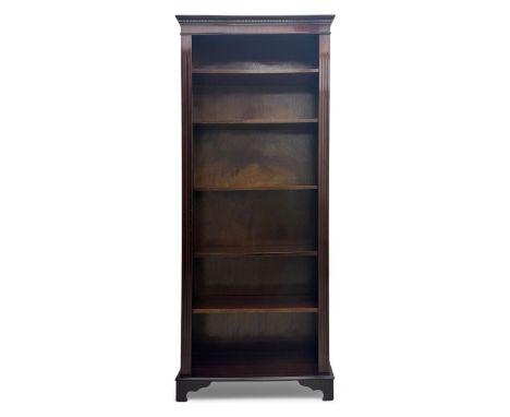 Early 20th century mahogany open bookcase, the rectangular top with dentil moulding, the sides with fluted decoration, fitted