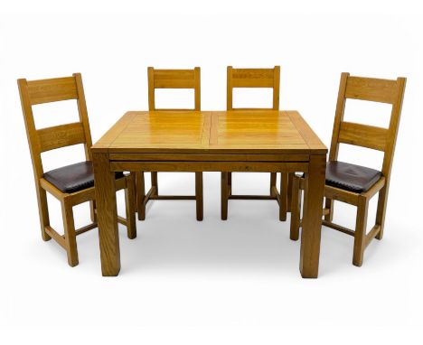 Contemporary oak dining table, rectangular panelled top with integral extension leaf, raised on square supports; set of four 