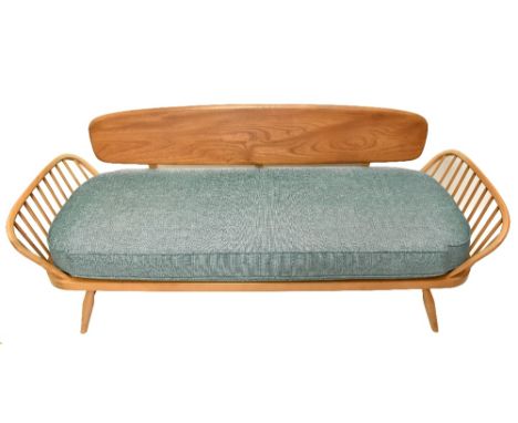 ERCOL; a light elm day bed, raised on tapering column supports,&nbsp;length 210cm.Additional InformationSunlight fading in pa