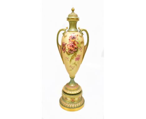 ROYAL WORCESTER; a large twin handled blush ivory pedestal urn vase and cover on stand, painted with floral decoration, overa