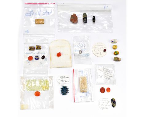 A mixed group of ancient carvings and trinkets including a late period Egyptian 'Multiple Eye' amulet, length 2cm, a tiny car