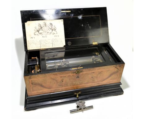 A good late 19th century walnut cased musical box with three interchangeable cylinders, each playing five airs, on stepped ba