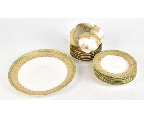 ROYAL WORCESTER; a part service with gilt floral decoration inside a jewelled border, puce factory marks to base.