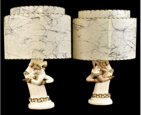 PUCCINI; a pair of painted plaster table lamps with relief moulded decoration representing Pierrettes, impressed marks to bas