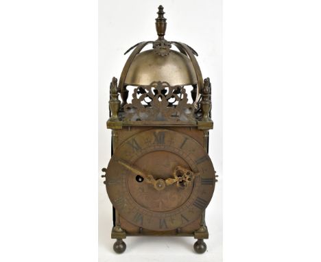 A 19th century brass lantern clock with turned finial above exposed bell and circular dial spuriously inscribed 'J. Knibb, Fe