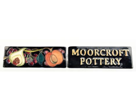 EMMA BOSSONS FOR MOORCROFT; an advertising triangular shaped plaque decorated in the 'Queen's Choice' pattern to reverse, imp