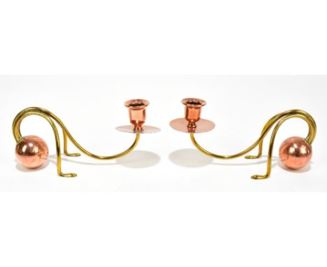 CARL DEFFNER; a pair of Arts &amp; Crafts copper and brass candlesticks with single arm supporting drip tray and sconce, one 
