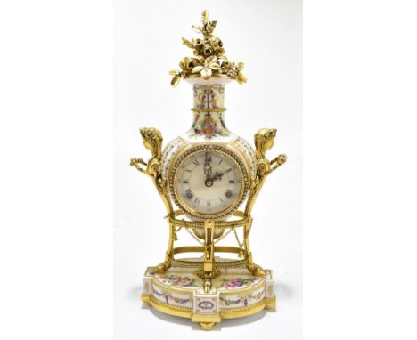 A reproduction twin handled ceramic mantel clock, the circular plastic dial with Roman and Arabic numerals flanked by gilt co