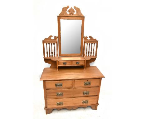A satin walnut dressing chest, the swing mirror flanked by turned spindles above two short drawers, the base with two short o