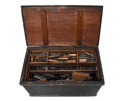 An old stained pine tool chest housing a large collection of assorted antique and later tools.