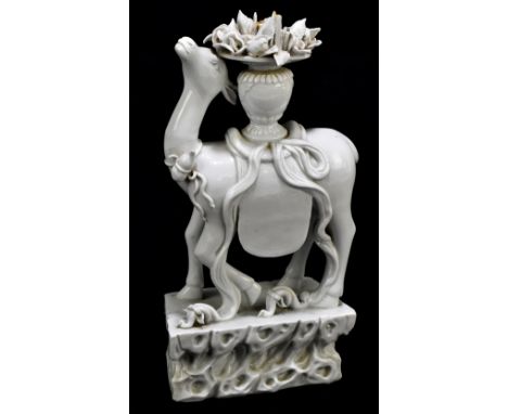 A Chinese blanc de Chine Dehua-type figure of a deer with gourd around its neck and with urn of flowers upon its back, height