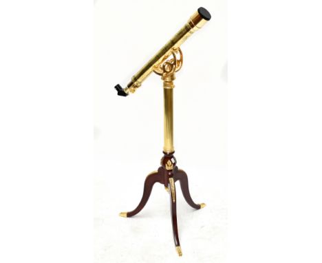 A modern reproduction telescope on tripod stand.