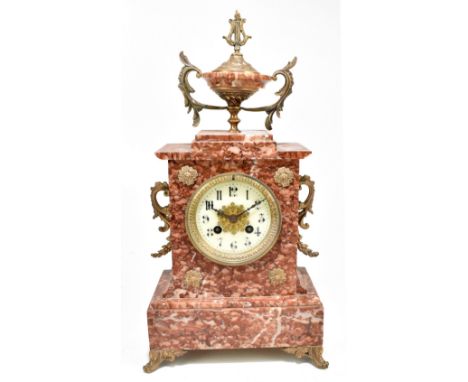 A late 19th century French rouge marble mantel clock with gilt metal twin handles and mounts, on cast scrolled front feet, th