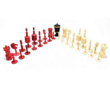 A late 19th century bone and stained bone carved chess set,&nbsp;height of king&nbsp;approx. 11.25cm, also a stained dice sha