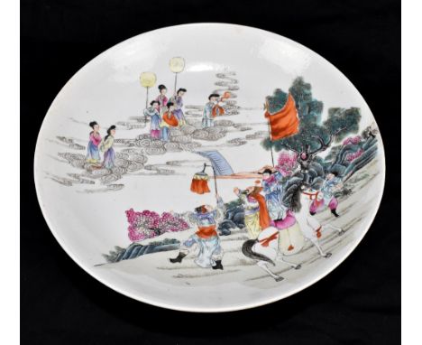 A late 19th century Chinese charger decorated with figures in clouds and further figures with a horse and lantern, painted fo