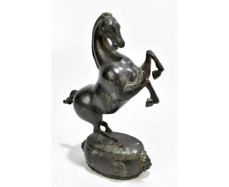A Japanese Meiji period bronze figure of a rearing horse raised on an oval drum shaped base, height 25cm.Additional Informati