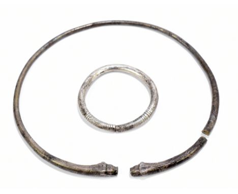 An ancient Danubian Celtic tribal white metal bangle with stylised incised detail, probably region of Macedonia, internal dia