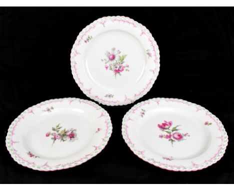 KPM; three early 20th century hand painted plates with moulded floral detail outside central hand painted floral sprays, sign