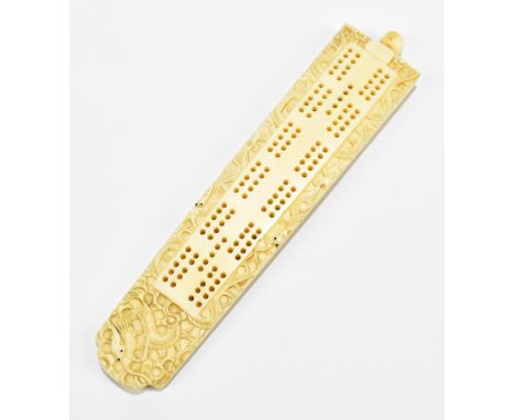 A late 19th century Chinese carved ivory cribbage board, carved with stylised dragons, length 18.5cm.Additional InformationGe