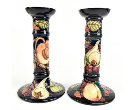 EMMA BOSSONS FOR MORRCROFT; a pair of candlesticks decorated in the 'Queen's Choice' pattern, impressed marks, signed in gilt