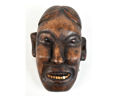 An early 20th century Naga headhunter's skull head taking status mask trophy, Konyak people of Nagaland, set with real teeth 