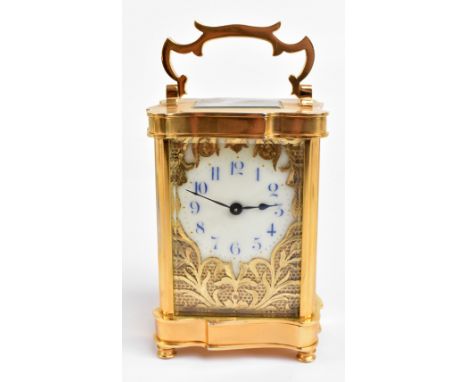 A&nbsp; late 19th century French brass cased carriage clock, the central enamel dial with Arabic numerals within a pierced sc