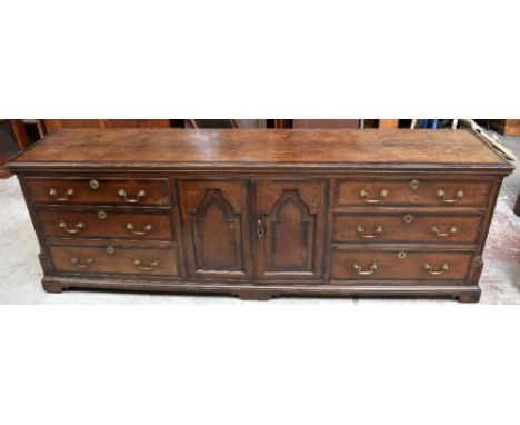 A good and large early 19th century oak and mahogany crossbanded North Country dresser base with two central cupboard doors s