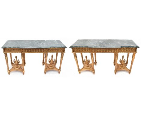 A pair of large decorative giltwood console tables of breakfront outline, with green marble tops above a single frieze drawer