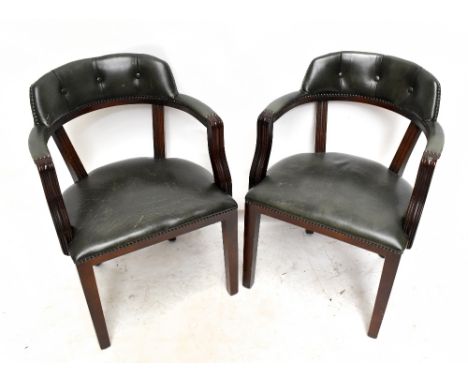 A pair of reproduction green leather button upholstered elbow chairs.