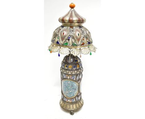 A highly decorative 20th century Moroccan fet table lamp and shade, the pierced metal shade inset with coloured glass above I