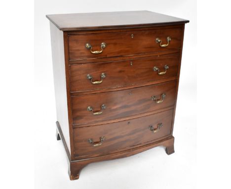 An early 20th century mahogany chest of four long graduated drawers of slightly bow front outline raised on splayed bracket f