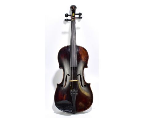 A full-size German violin with grotesque carved scroll, indistinctly inscribed to interior, the one-piece back length 35.2cm,