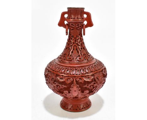 A Chinese red cinnabar style vase with ring loop handles, height 19cm.Additional InformationThis is a modern piece and is not