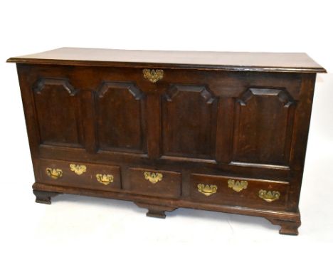 An 18th century oak coffer with panelled decoration to the front above three base drawers, raised on bracket feet, length 158
