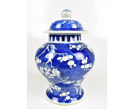 A late 19th century Chinese blue and white jar and cover painted with prunus flowers, double ring Kangxi mark to base, height
