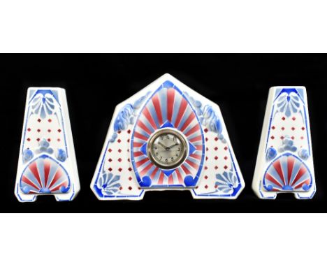CERANORD; a French Art Deco ceramic clock garniture with stylised red and blue moulded and starburst detail, the circular dia