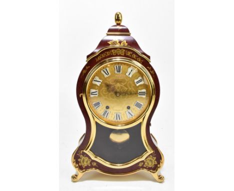 ELUXA; a Swiss shaped mantel clock with boulle-effect finish and gilt metal mounts, the signed circular dial set with Roman n