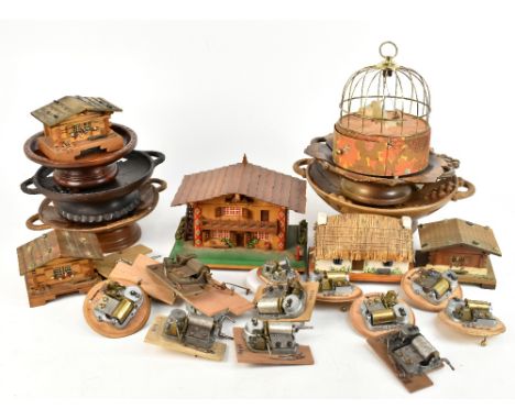 Four Black Forest type musical carved wooden bowls, some with labels detailing Swiss movements,&nbsp;diameter of largest 32.5