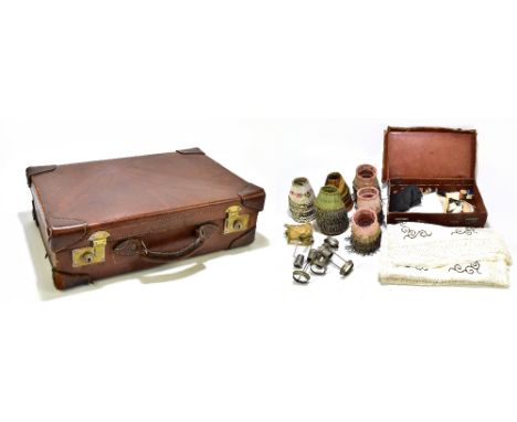 A vintage leather suitcase, length 55cm, together with a smaller suitcase stamped 'M.C.C.' and various lamp shades and fittin