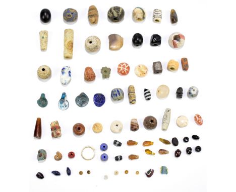 A group of ancient jewellery beads including ceramic and glass examples, one bead with millefiori-type detail (some af).Prove