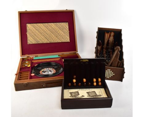 An English made cased games compendium housing a Roulette wheel, chess pieces, checkers, chess board, also an unusual treen c