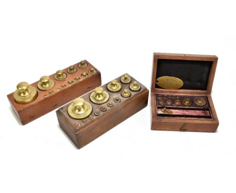 Three sets of brass Post Office weights, various sizes.