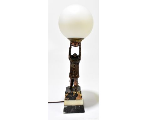 A French Art Deco style bronzed table lamp depicting a Pierette supporting a frosted glass shade, raised on stepped marble pl