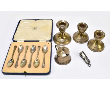 A group of hallmarked silver to include a pair of Elizabeth II candlesticks (weighted), a similar single example, a cased set