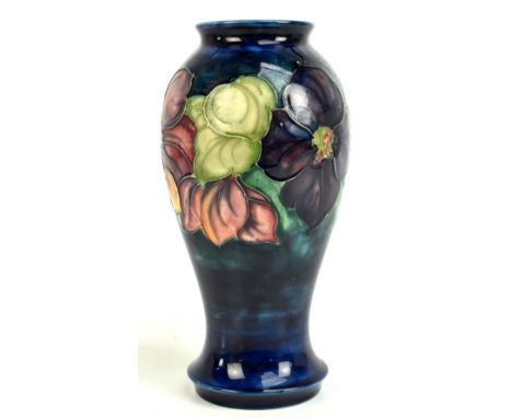 WALTER MOORCROFT; a vase&nbsp;decorated in the&nbsp;'Clematis' pattern on a blue ground, with blue signature and impressed ma