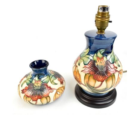 NICOLA SLANEY FOR MOORCROFT; two pieces decorated in the 'Anna Lily' pattern comprising a baluster table lamp, raised on wood