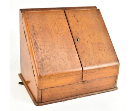 An early 20th century light oak stationery cabinet, the hinged doors enclosing fitted compartments, height 35cm, width 40cm, 